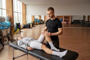 Patient getting physical rehabilitation by therapist